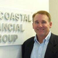 Chris Berkeley standing next to Intercoastal Financial Group sign